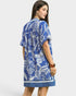 Woman wearing a blue and white patterned dress on a white background