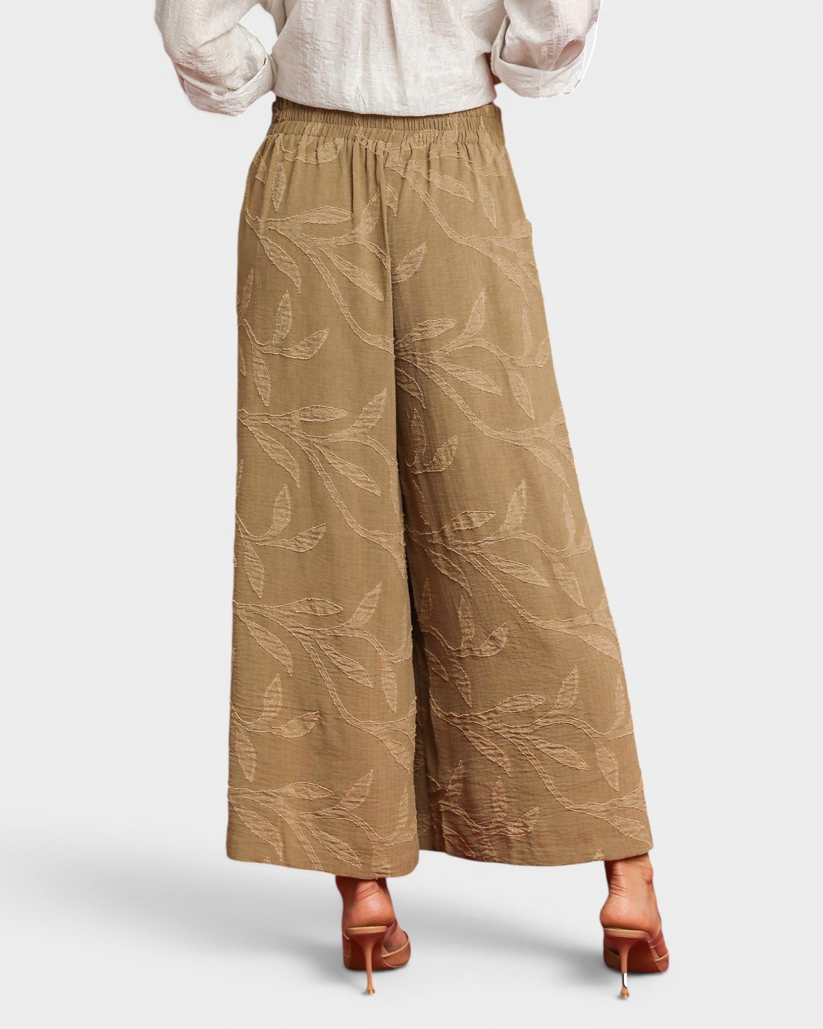 Brown wide-leg pants worn by a person on a light gray background