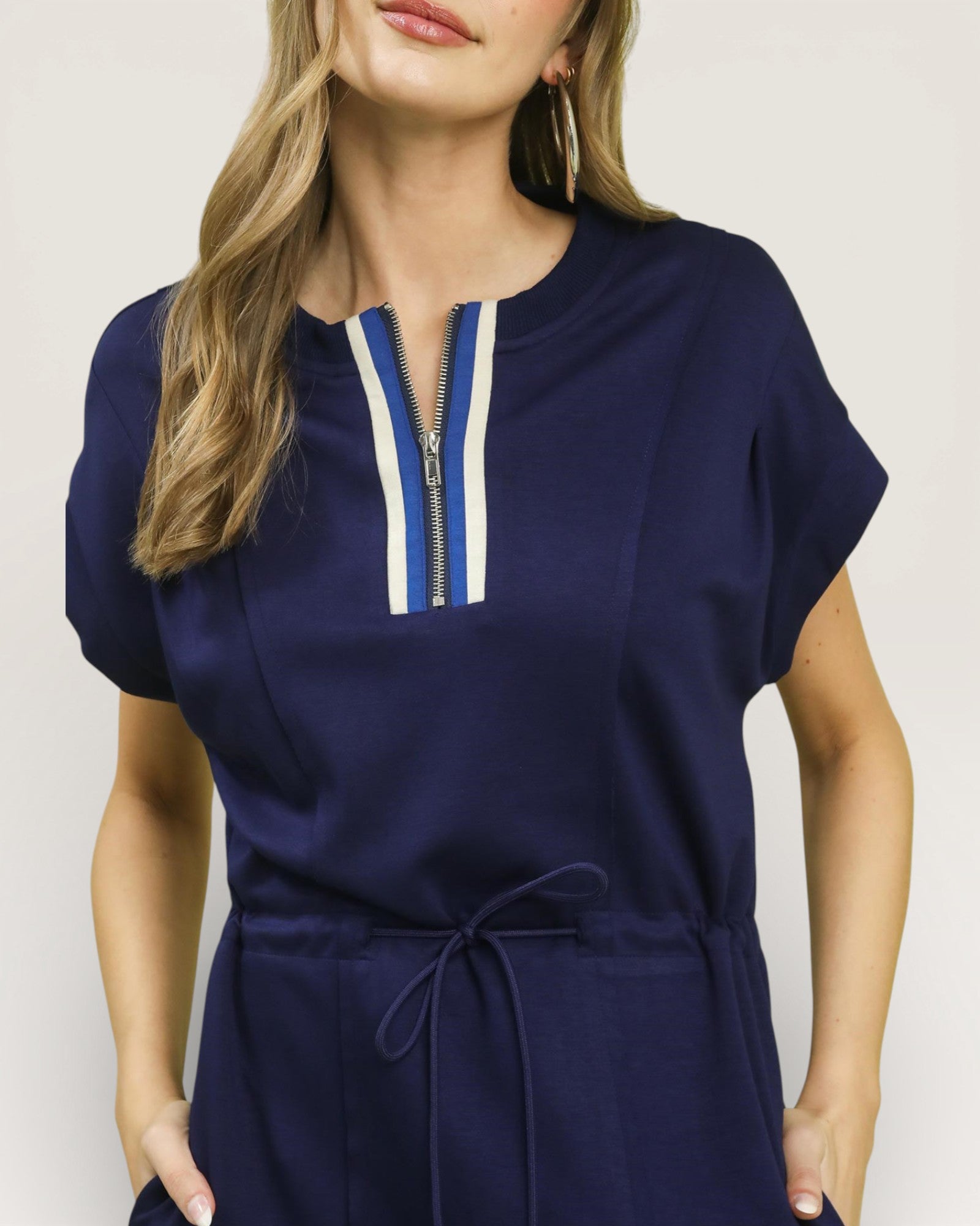 Navy blue dress with a zipper detail on a plain background
