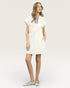 Woman wearing a white dress with a blue stripe on a plain background