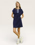 Woman wearing a navy blue dress with a white background