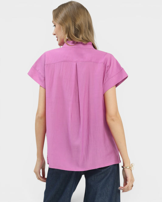 Woman wearing a pink short-sleeve blouse on a white background