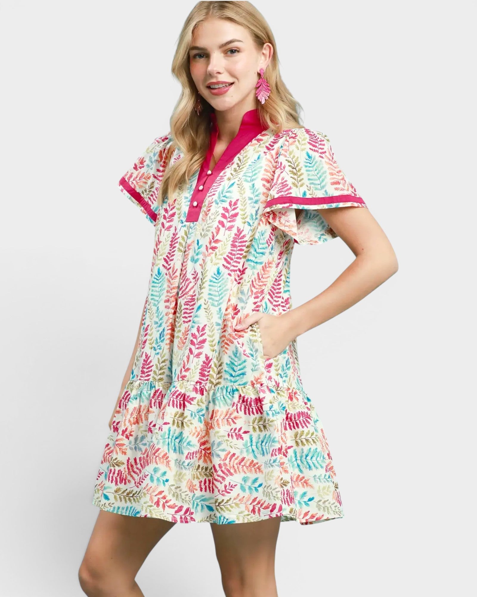 Woman wearing a colorful patterned dress on a white background