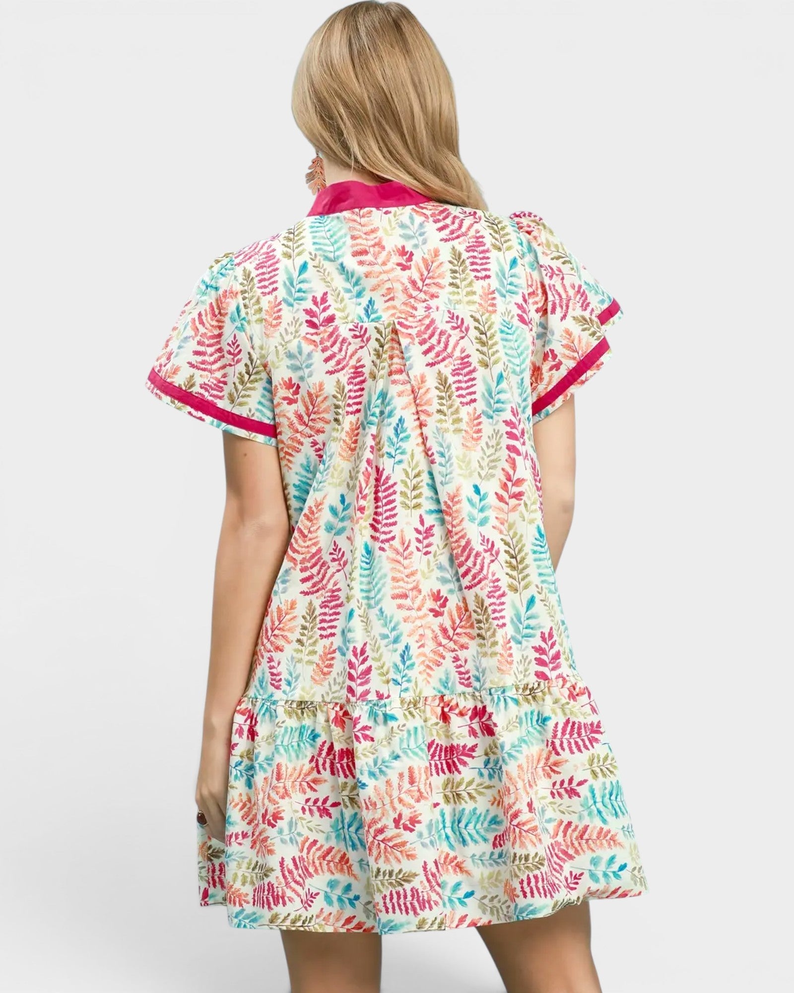 Woman wearing a colorful patterned dress on a white background