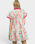 Woman wearing a colorful patterned dress on a white background