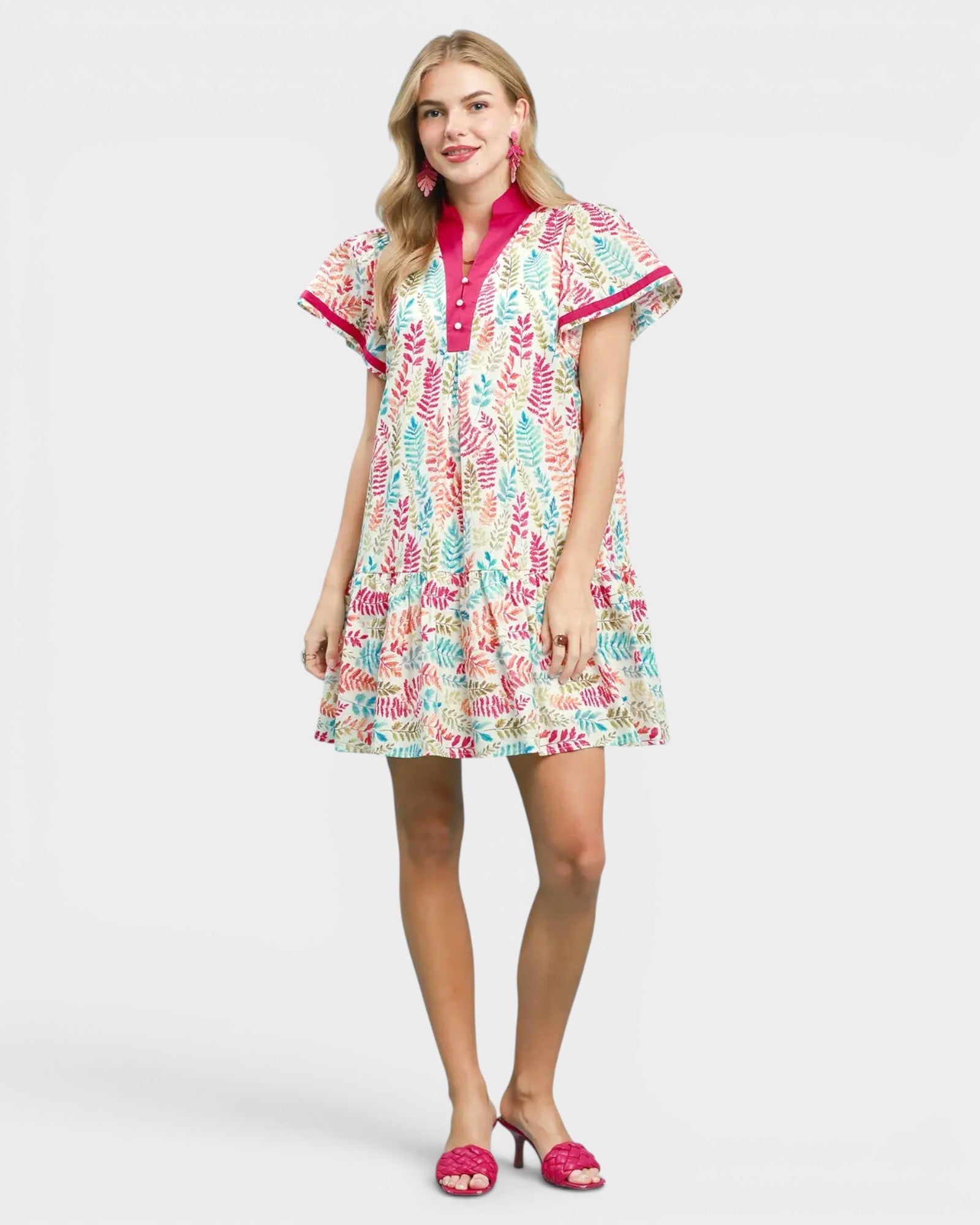 Woman wearing a colorful patterned dress on a white background
