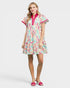 Woman wearing a colorful patterned dress on a white background