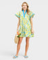 Woman wearing a colorful dress with a white background