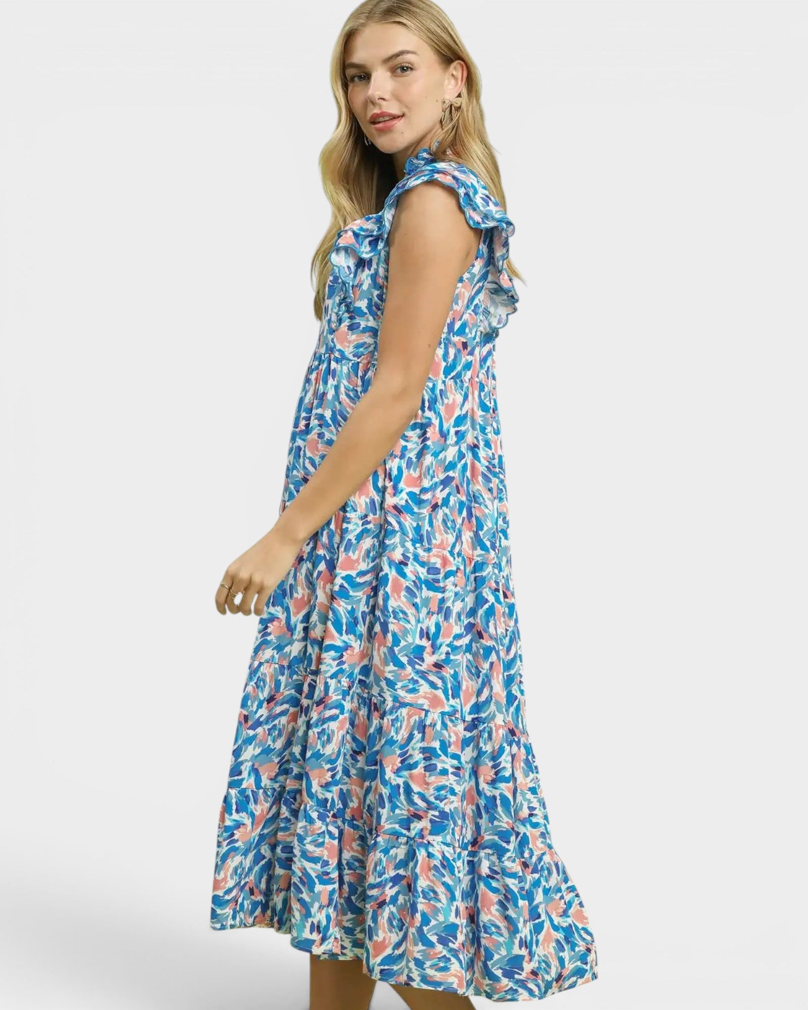 Woman wearing a blue floral dress on a white background