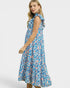 Woman wearing a blue floral dress on a white background