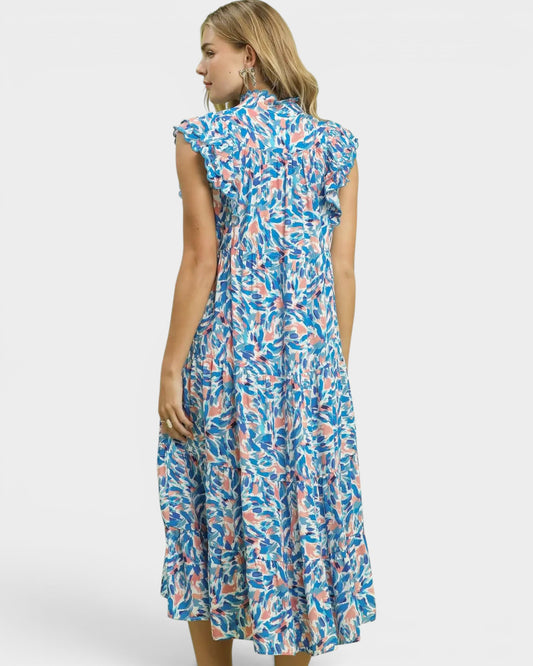 Woman wearing a blue and pink patterned dress on a white background