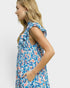 Woman wearing a blue and pink floral dress on a white background
