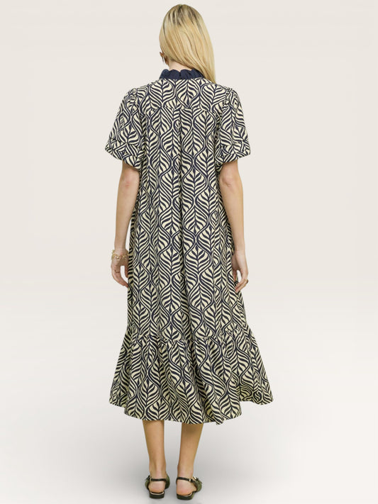 Woman wearing a patterned dress on a white background