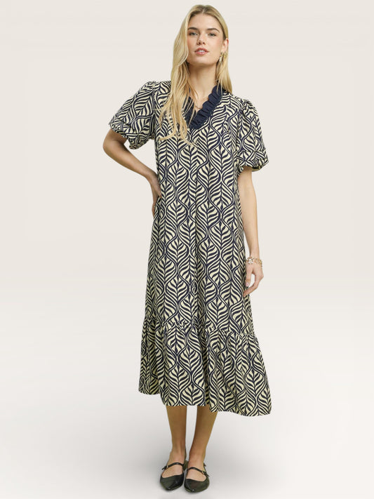 Woman wearing a patterned dress on a white background