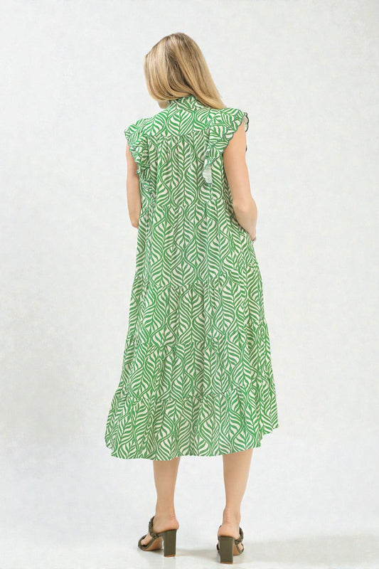 Woman wearing a green patterned dress on a white background