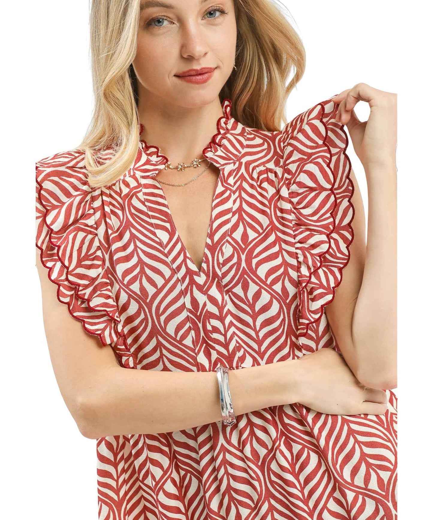 Woman wearing a red and white patterned dress on a white background