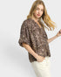 Woman wearing a leopard print blouse on a white background