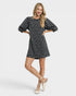 Woman wearing a black leopard dress on a white background