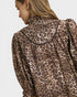 Leopard print jacket worn by a person on a plain background