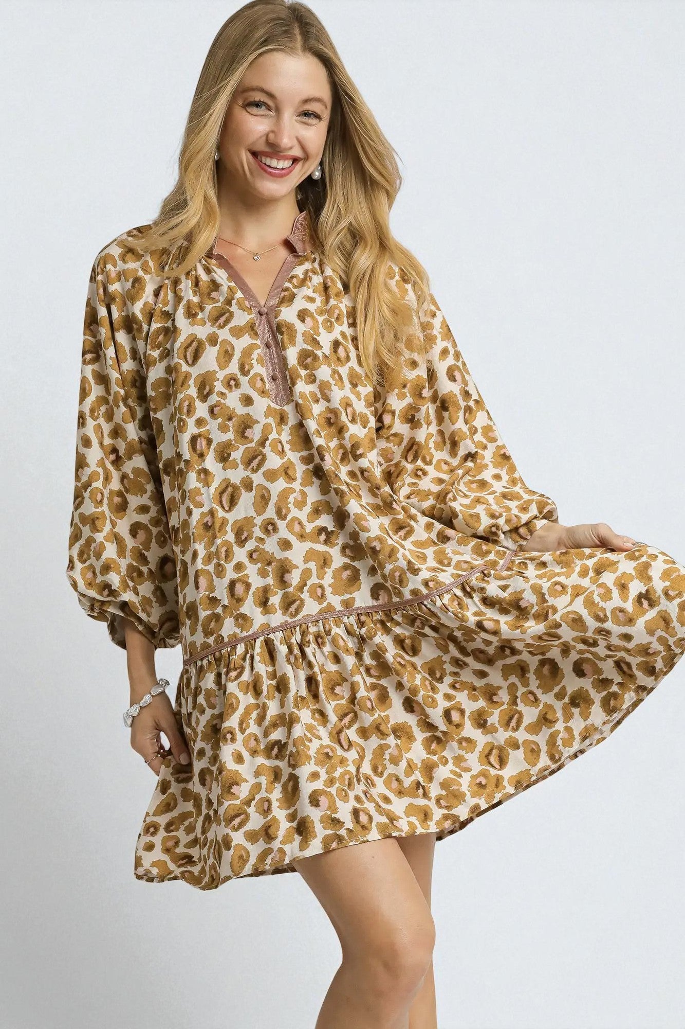 Woman wearing a leopard print dress on a white background