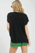 Woman wearing a black top and green shorts on a white background