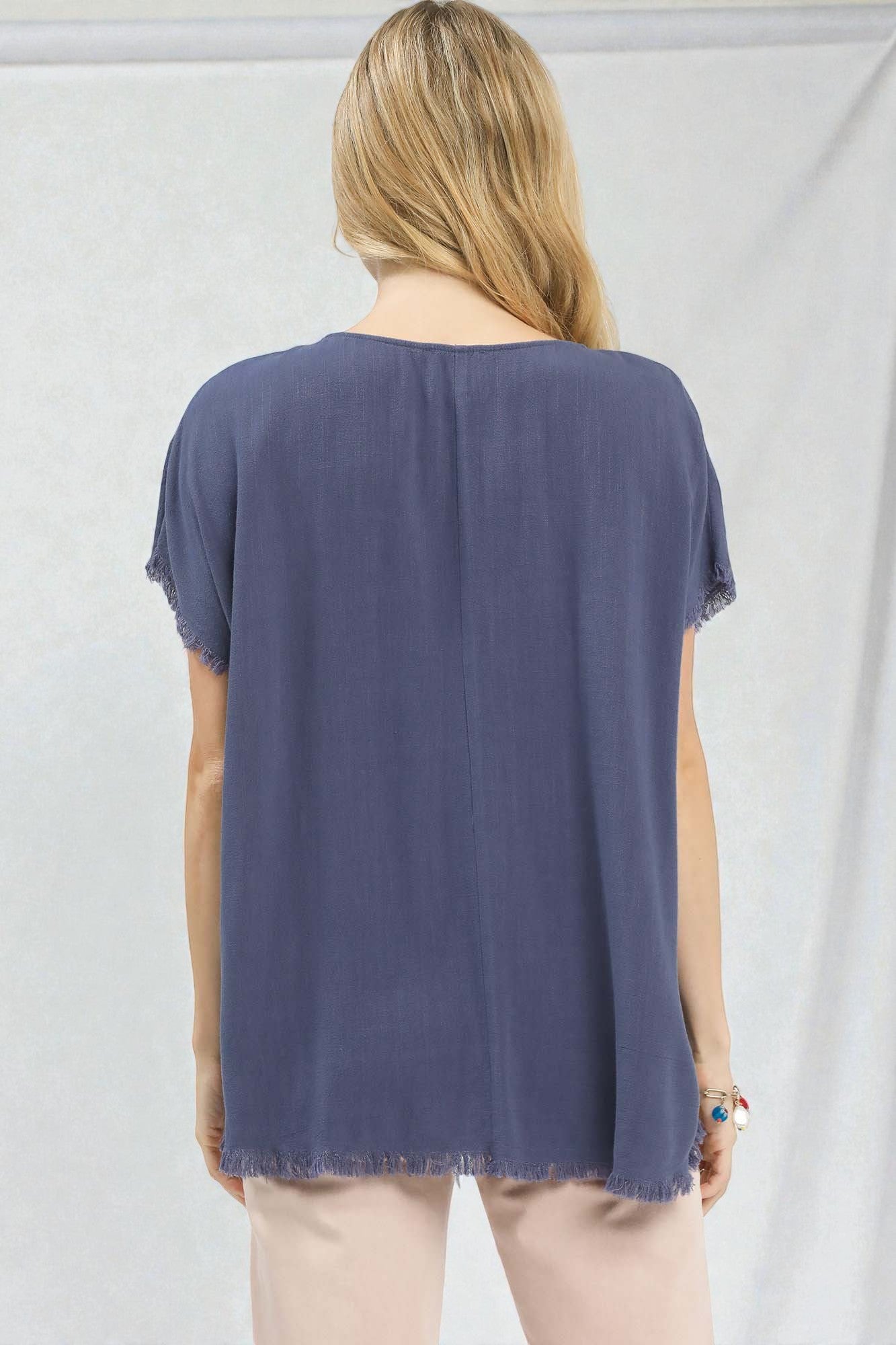 Person wearing a blue t-shirt against a white background