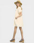 Woman wearing a beige dress and hat on a white background