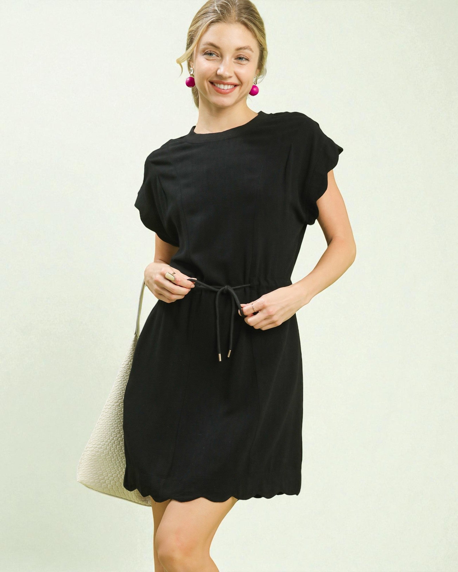 Woman wearing a black dress with a white background