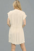 Beige sleeveless dress worn by a person on a gray background