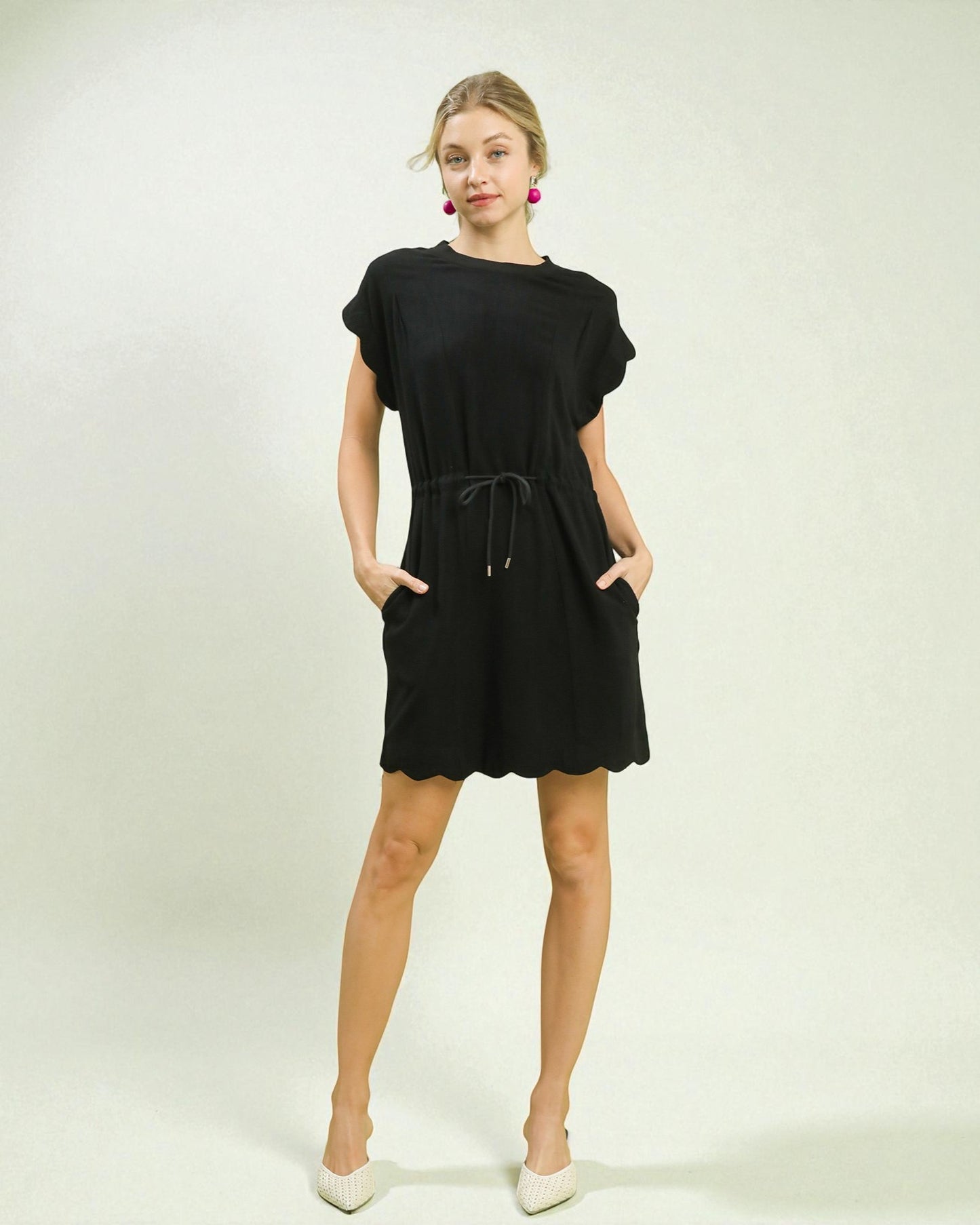 Woman wearing a black dress with a white background