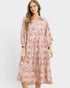 Woman wearing a red floral dress on a white background