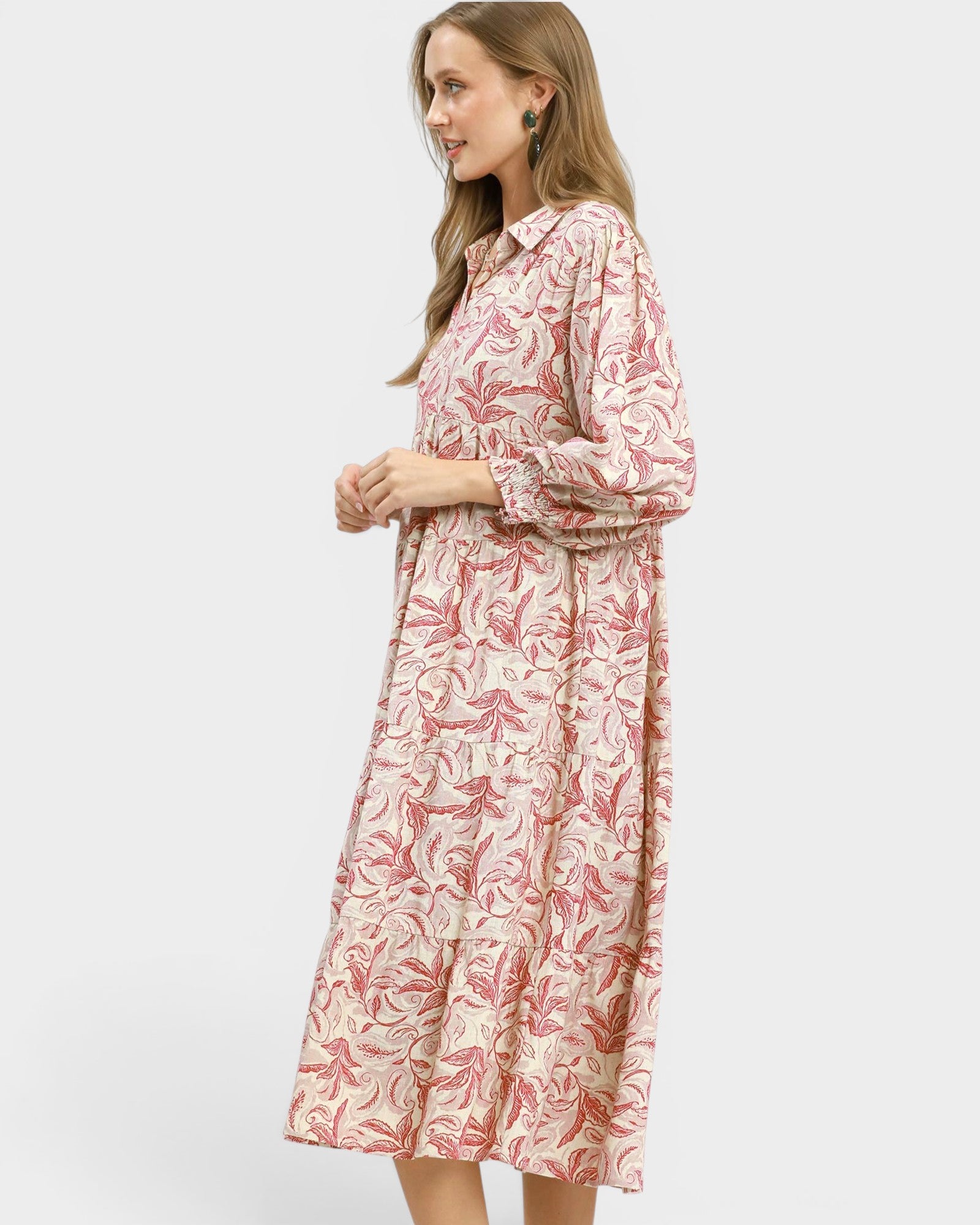 Woman wearing a pink floral dress on a white background