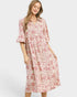 Woman wearing a pink floral dress on a white background