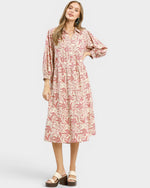 Woman wearing a pink floral dress on a white background