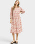 Woman wearing a pink floral dress on a white background