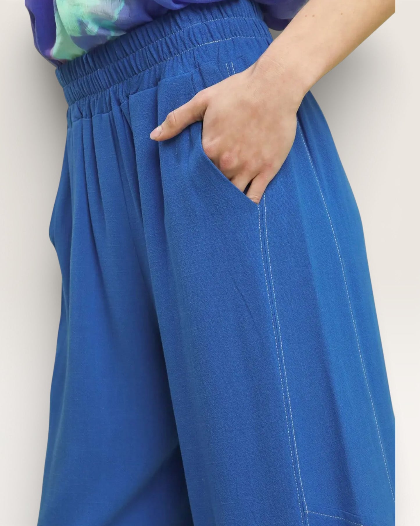 Blue pants worn by a person with a white background