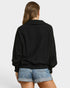Person wearing a black sweater and denim shorts on a white background
