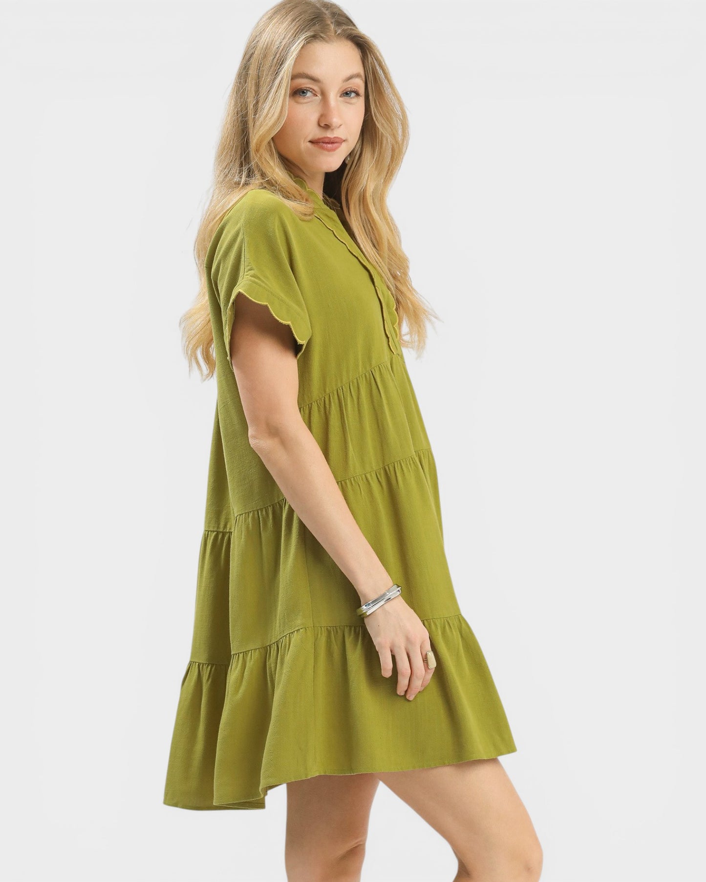 Woman wearing a green dress on a white background