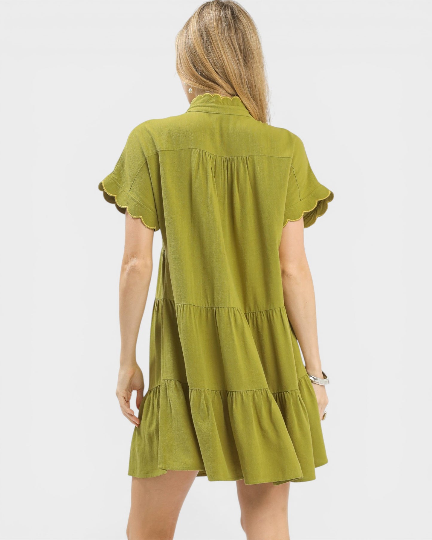 Green dress worn by a person on a white background