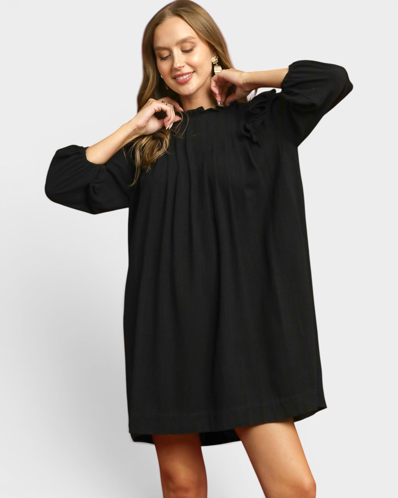 Woman wearing a black dress on a white background