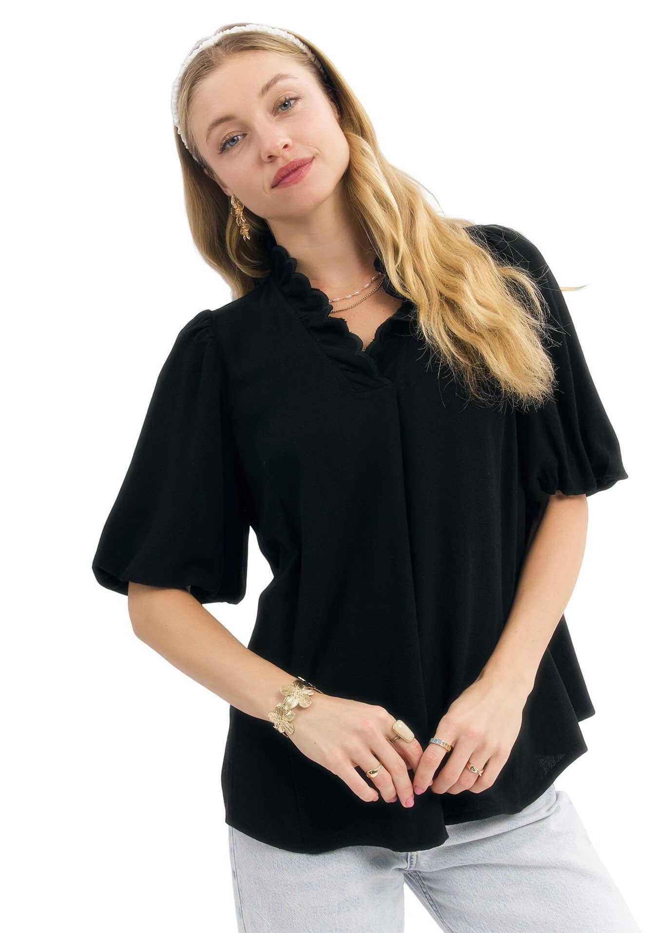 Woman wearing a black blouse with short sleeves on a white background