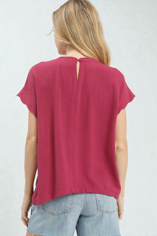 Woman wearing a red t-shirt with a cut-out back design on a white background