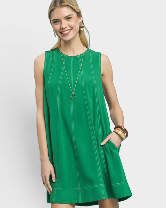 Woman wearing a green dress on a white background
