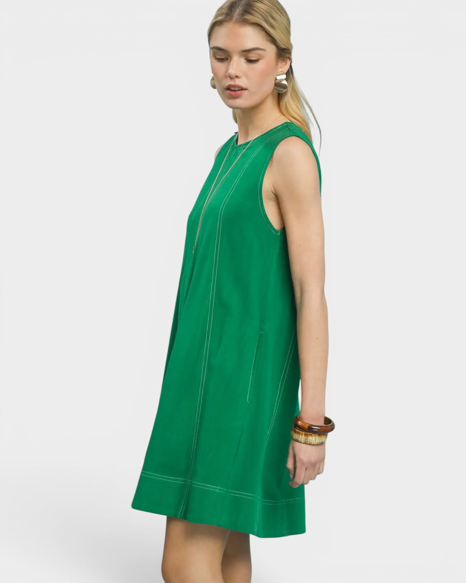Woman wearing a green dress on a white background