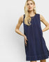 Woman wearing a navy blue dress against a white background