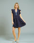 Woman wearing a navy blue dress with ruffled sleeves on a gray background