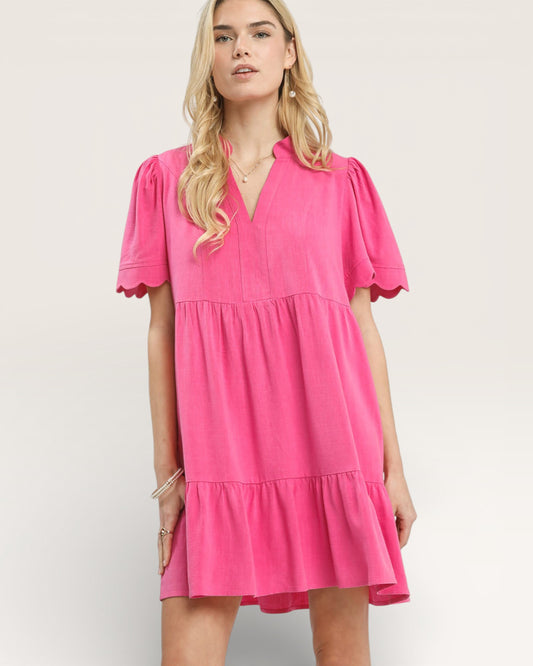 Woman wearing a pink dress on a white background