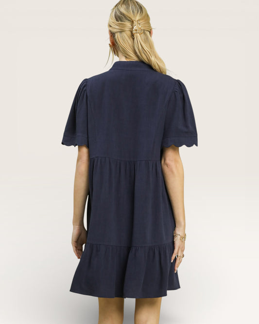 Navy blue dress worn by a person on a white background