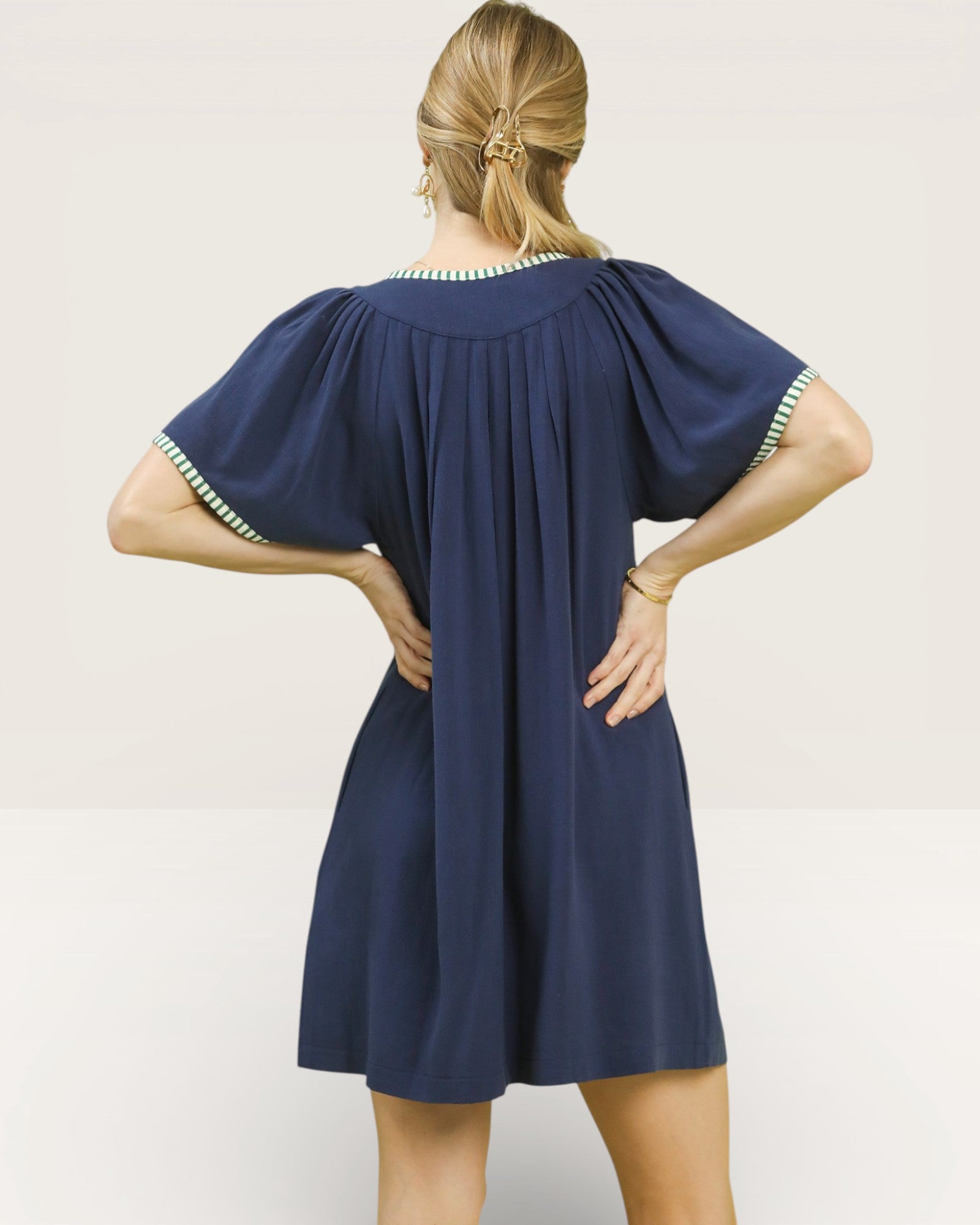 Navy blue dress with short sleeves and a round neckline on a white background
