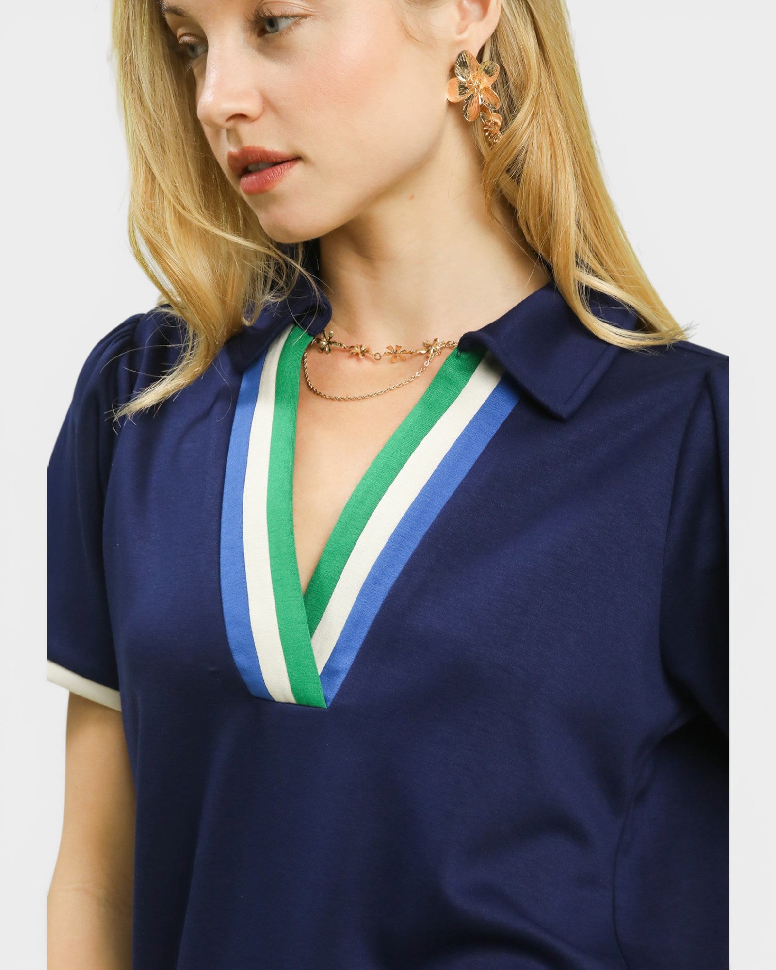 Navy blue blouse with colorful collar details on a plain background